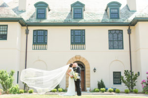 bride and groom kiss outside Westchester NY wedding venue