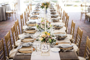 rustic reception table settings at tented wedding
